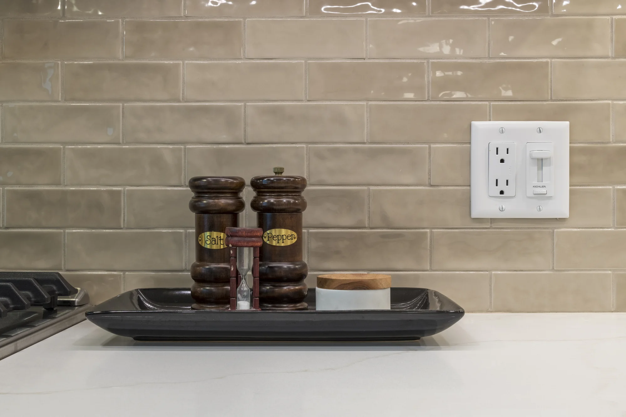 Neutral tile backsplash and light countertop detail